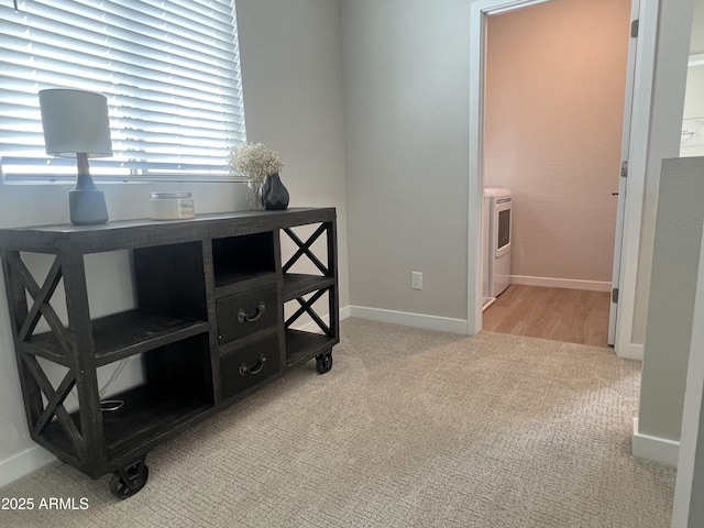 interior space featuring washer / clothes dryer and light carpet