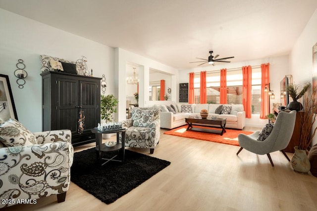 living room featuring ceiling fan and wood-type flooring