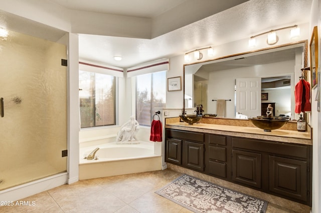 18919 E Reata Ln, Rio Verde, AZ 85263 - full bathroom featuring a garden tub, double vanity, a stall shower, a sink, and tile patterned flooring