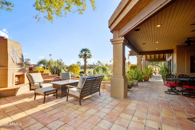 18919 E Reata Ln, Rio Verde, AZ 85263 - view of patio / terrace with outdoor dining area, ceiling fan, and an outdoor living space with a fireplace