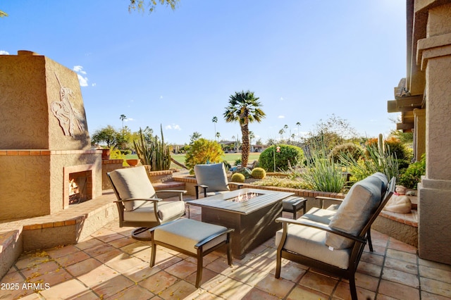 18919 E Reata Ln, Rio Verde, AZ 85263 - view of patio featuring a fire pit and an outdoor stone fireplace