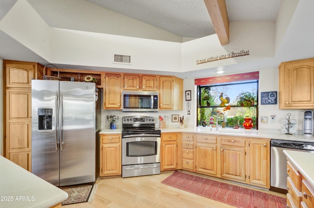18919 E Reata Ln, Rio Verde, AZ 85263 - kitchen featuring light wood-style flooring, stainless steel appliances, a sink, visible vents, and light countertops