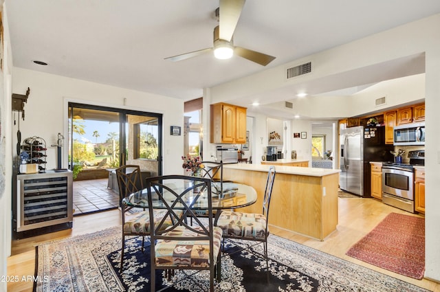 18919 E Reata Ln, Rio Verde, AZ 85263 - dining area featuring wine cooler, visible vents, ceiling fan, and light wood finished floors