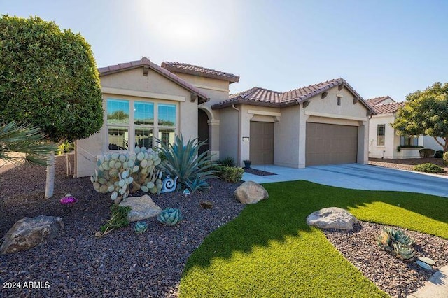 mediterranean / spanish-style home with a garage