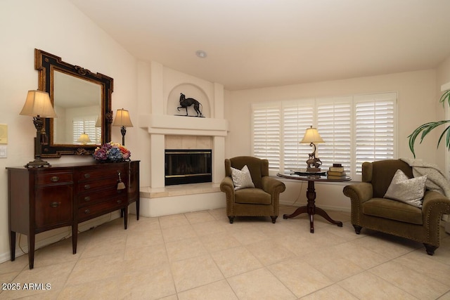 sitting room with a fireplace, a wealth of natural light, and light tile patterned flooring