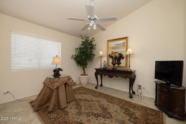 interior space featuring lofted ceiling, light tile patterned floors, a ceiling fan, and baseboards