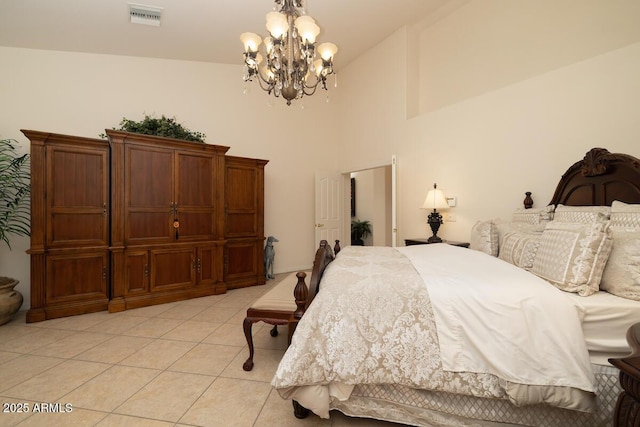 bedroom featuring light tile patterned floors, visible vents, and an inviting chandelier