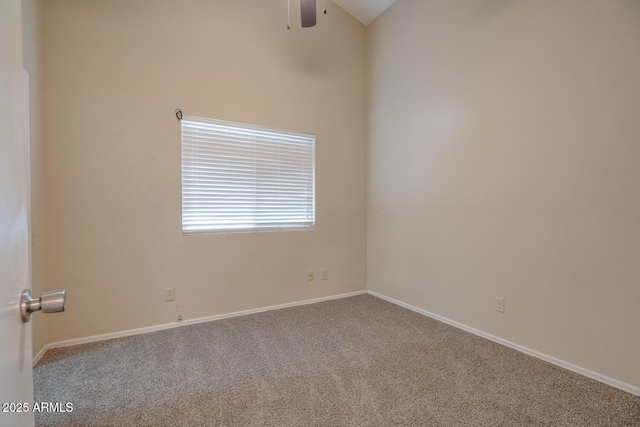 carpeted spare room featuring lofted ceiling and ceiling fan