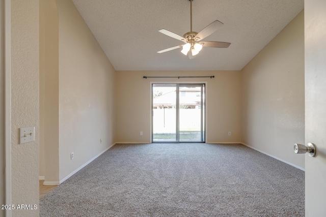 carpeted empty room with lofted ceiling, a textured ceiling, and ceiling fan