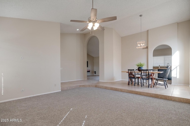 carpeted dining space featuring ceiling fan and a textured ceiling