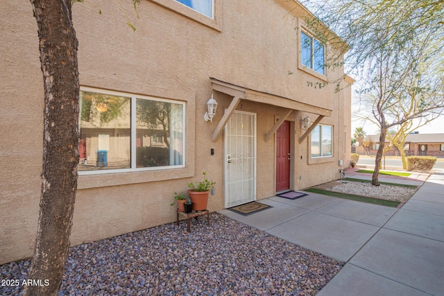 property entrance featuring stucco siding