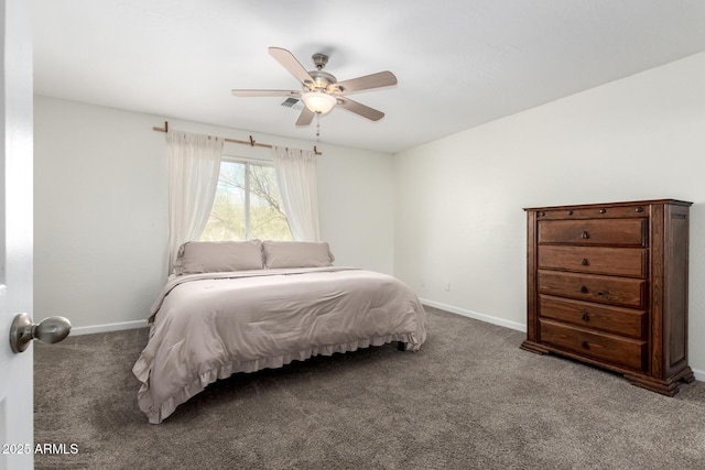 carpeted bedroom with ceiling fan and baseboards