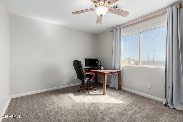 carpeted home office featuring visible vents, baseboards, and a ceiling fan