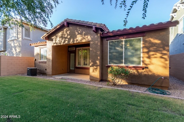 rear view of property with a yard