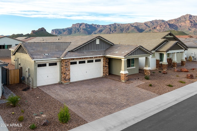 ranch-style house with a mountain view and a garage