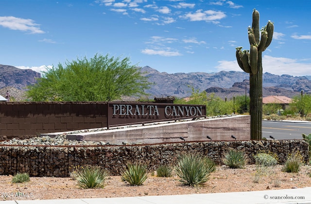 community / neighborhood sign with a mountain view