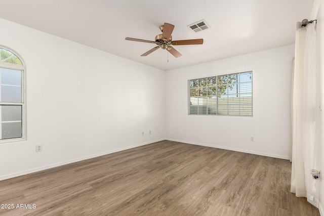 860 N Mcqueen Rd Unit 1157, Chandler, AZ 85225 - spare room featuring healthy amount of natural light, wood finished floors, ceiling fan, and baseboards