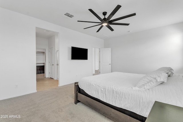 carpeted bedroom featuring a closet, a spacious closet, and ceiling fan