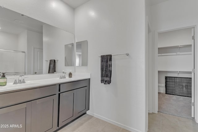 bathroom with tile patterned floors, vanity, and a shower with shower door