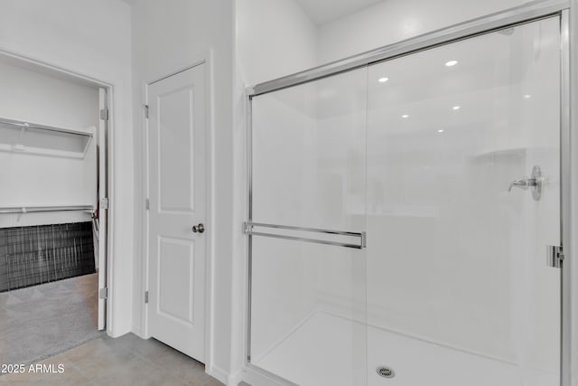 bathroom with tile patterned flooring and a shower with door