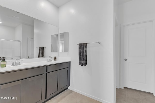 bathroom with vanity and a shower with shower door