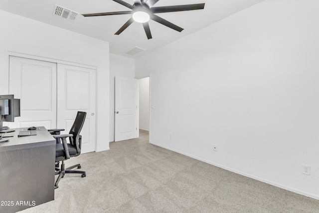 carpeted office space with ceiling fan