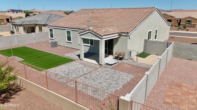 rear view of property featuring a patio area and central AC unit