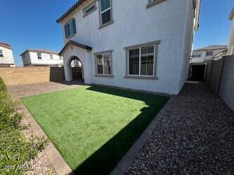 back of property with a yard and a patio