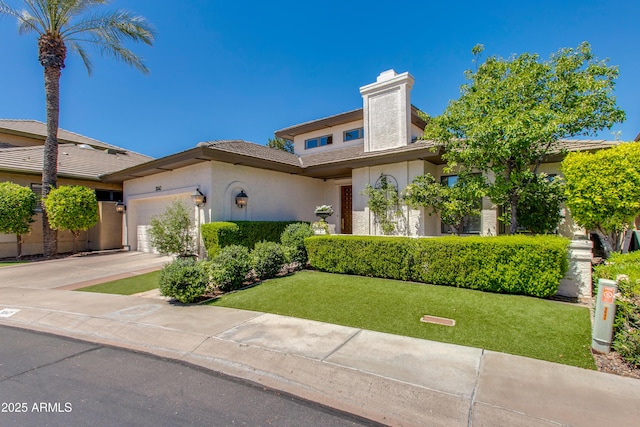 view of front of property featuring a garage and a front yard