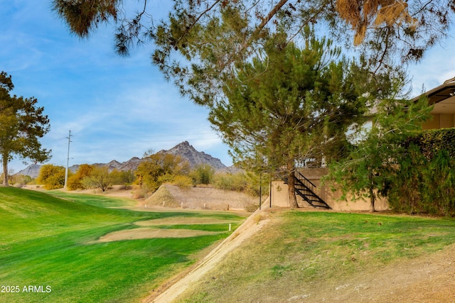 view of property's community featuring a mountain view and a yard