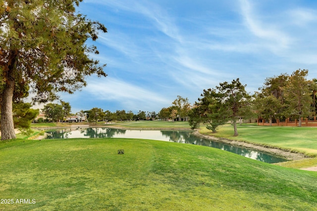 view of property's community featuring a yard and a water view