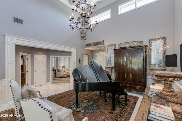 miscellaneous room with ornamental molding and a high ceiling