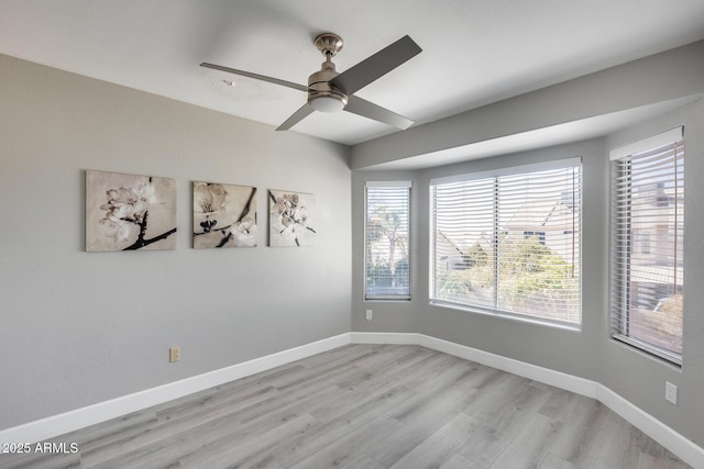 empty room with ceiling fan and light wood-type flooring