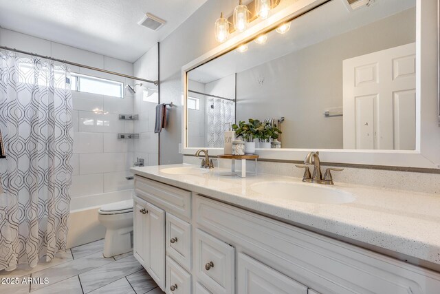 full bathroom with vanity, shower / bath combination with curtain, and toilet