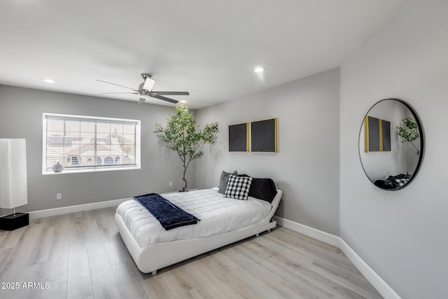 bedroom with ceiling fan and light wood-type flooring