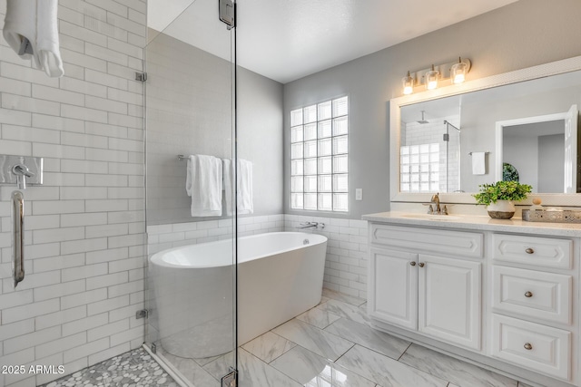 bathroom with vanity, independent shower and bath, and tile walls