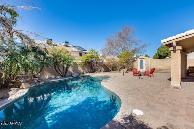 view of pool with a storage unit and a patio