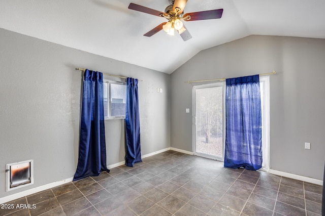 empty room featuring lofted ceiling, a wealth of natural light, and ceiling fan