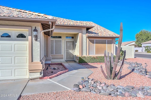 view of exterior entry with a garage