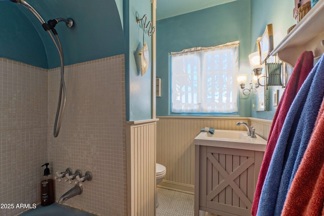 full bathroom featuring toilet, vanity, tiled shower / bath, and tile patterned flooring