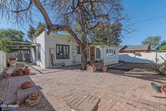 rear view of property featuring a patio area