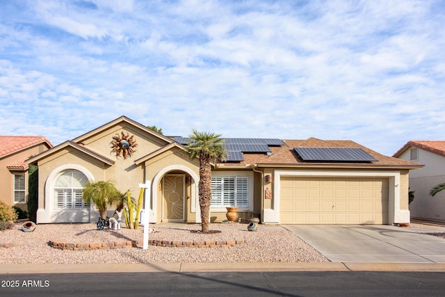 view of front of house featuring a garage and solar panels