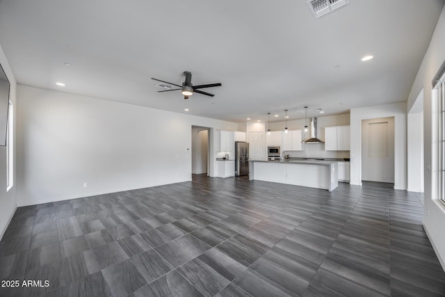 unfurnished living room featuring recessed lighting, visible vents, and ceiling fan
