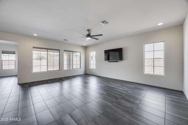 unfurnished living room with dark tile patterned floors, visible vents, recessed lighting, and ceiling fan