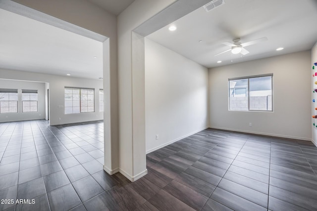 spare room with baseboards, visible vents, recessed lighting, ceiling fan, and dark tile patterned floors