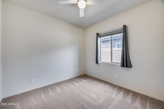 spare room with baseboards, a ceiling fan, and carpet flooring