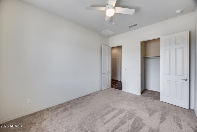 unfurnished bedroom featuring a closet, visible vents, carpet flooring, and ceiling fan