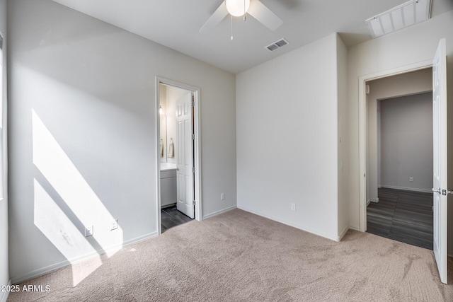 unfurnished bedroom with visible vents, connected bathroom, baseboards, carpet floors, and a ceiling fan