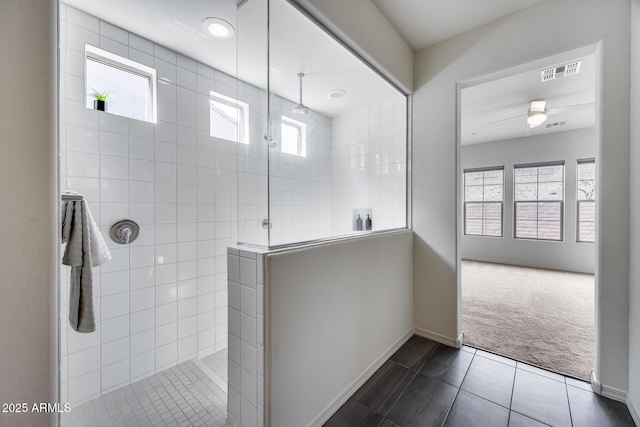 bathroom with tile patterned floors, a healthy amount of sunlight, visible vents, and walk in shower