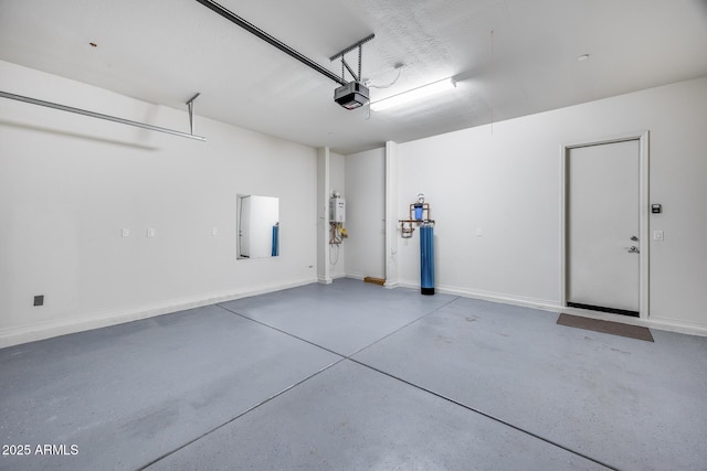 garage featuring a garage door opener and baseboards